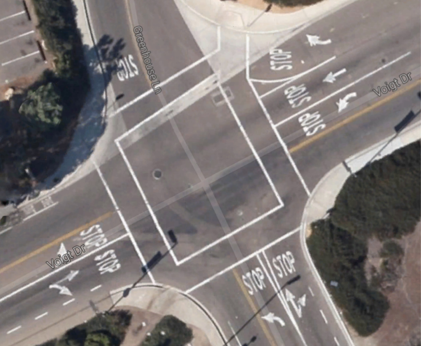 One of the intersections observed in the study was at Voight and Gilman in La Jolla, California. Lanes entering the intersection are marked with the word *STOP*. The amount of traffic that drivers dealt with was quantified as the number of lanes that were already occupied by other vehicles as drivers approached. For example, if there were vehicles waiting in two other lanes as a driver approached, then traffic was coded as two. Image courtesy of Google.